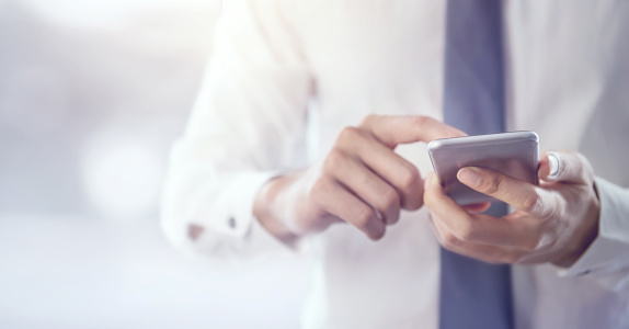 gentleman typing on cell phone