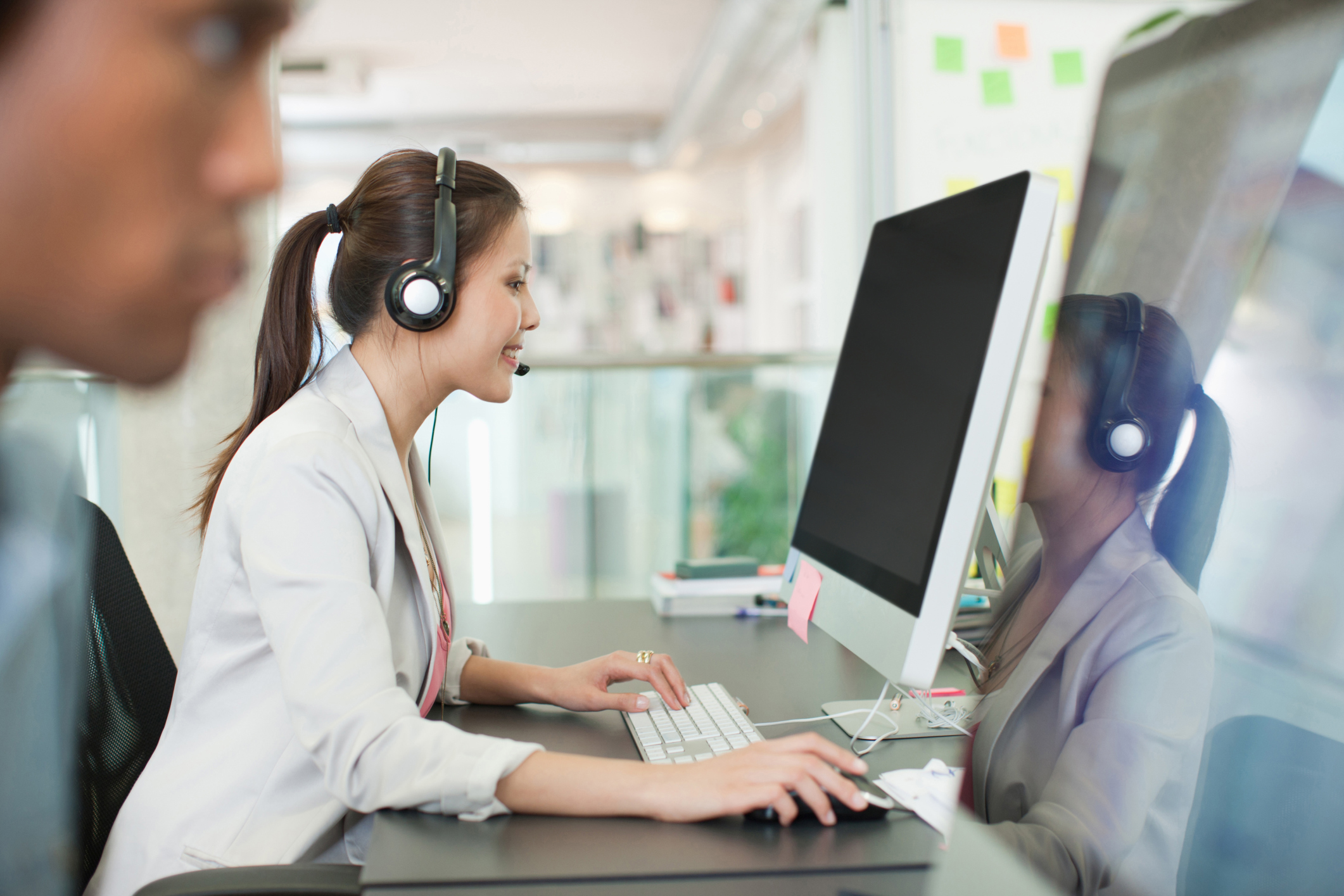 business woman with headset on working in office