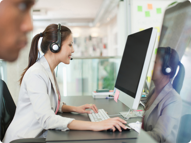 woman on computer talking on headset