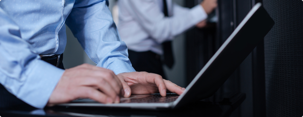 close-up of gentleman typing on laptop