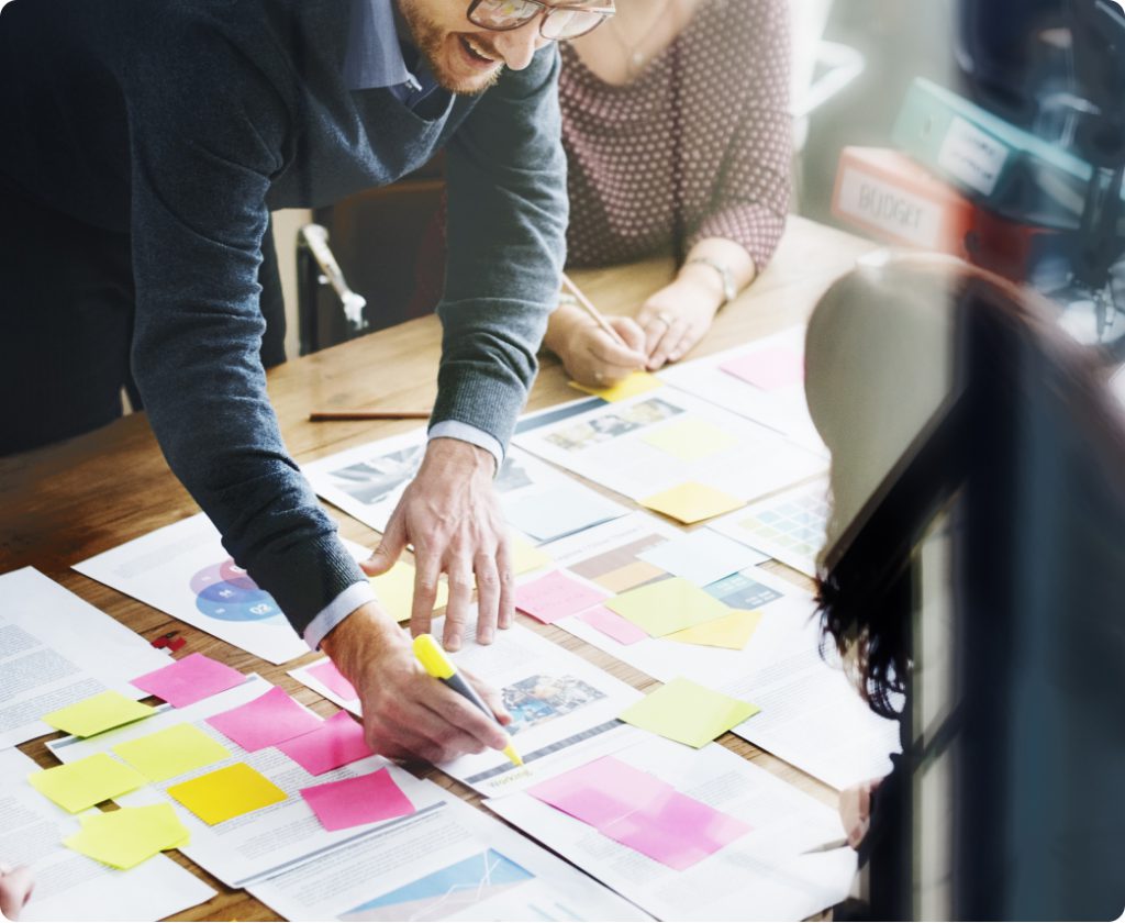 business man highlighting information on document in meeting