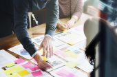 business man highlighting information on document in meeting