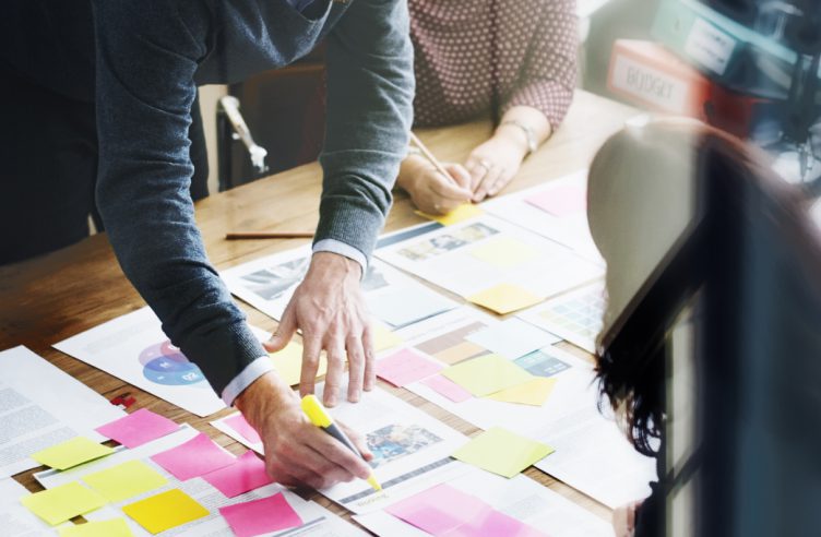 business man highlighting information on document in meeting