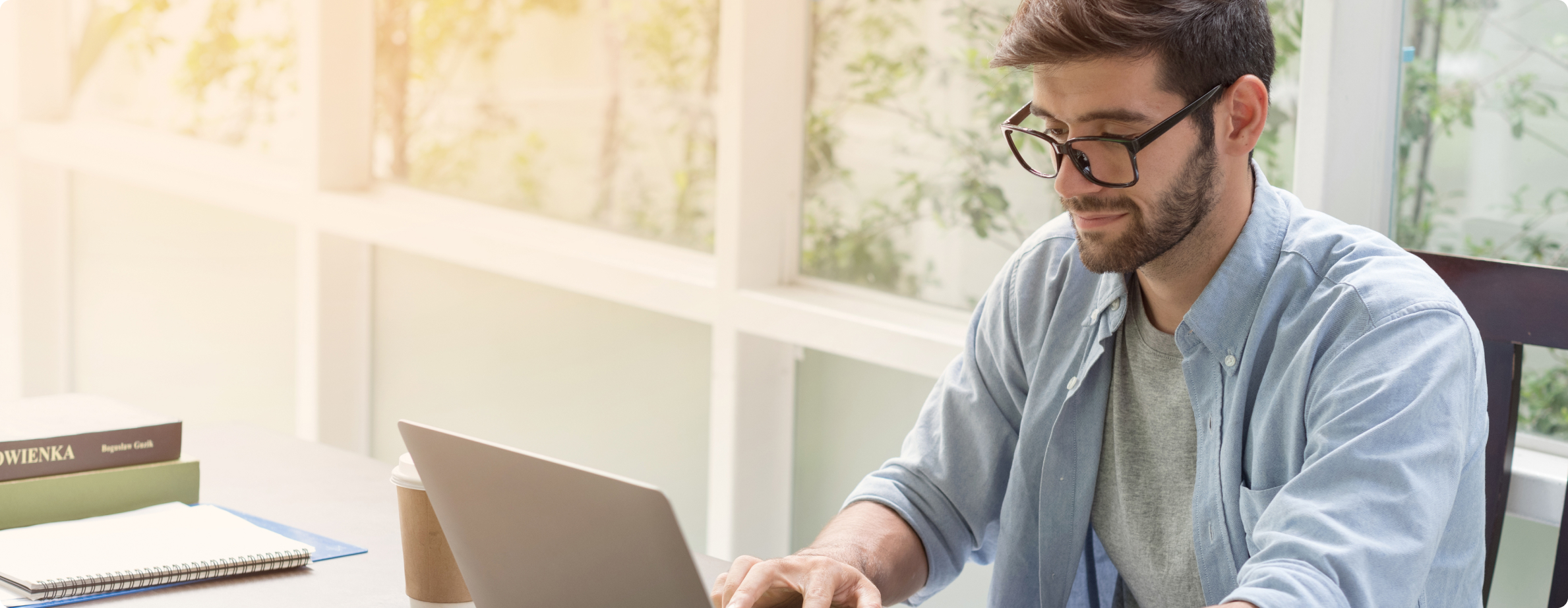 close-up of gentleman typing on laptop