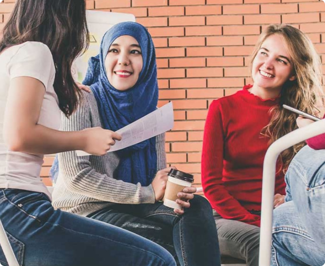 group of girls sitting down having a conversation