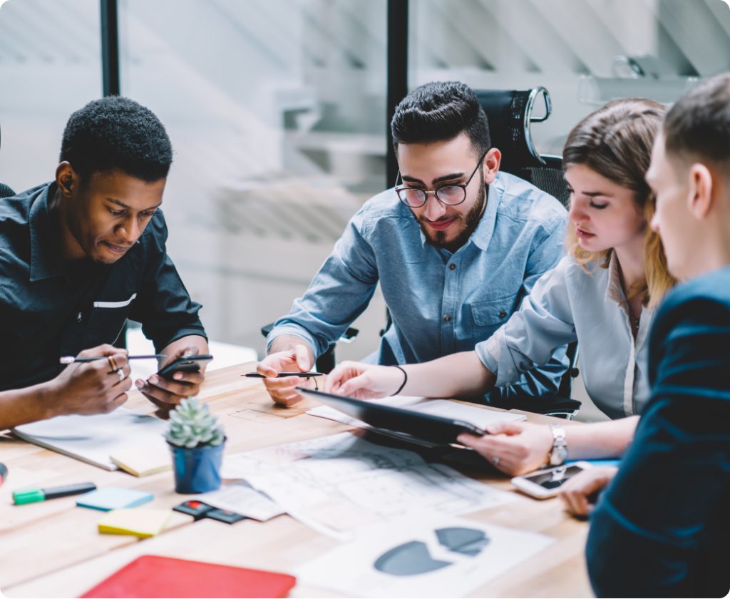 group of coworkers going over information at table