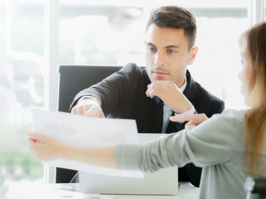 gentleman and woman going over document papers