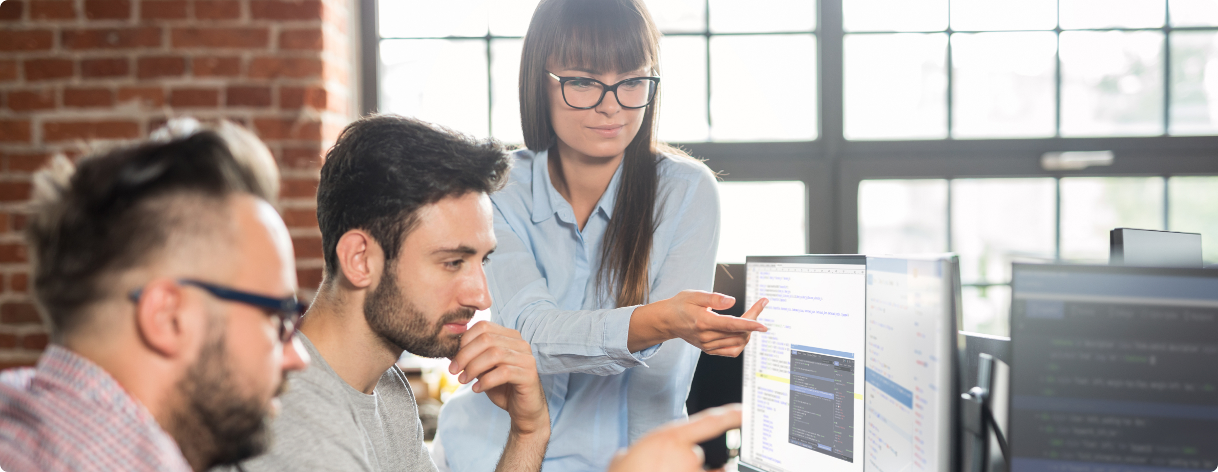 woman helping gentleman on computer