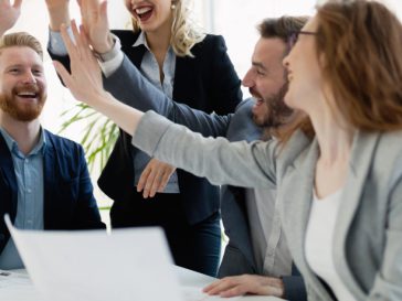 group of coworkers high fiving