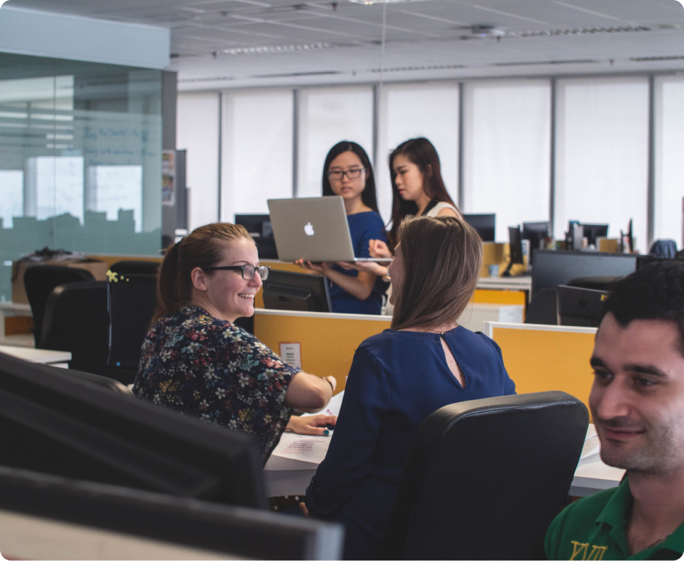 group of ladies talking at their desk