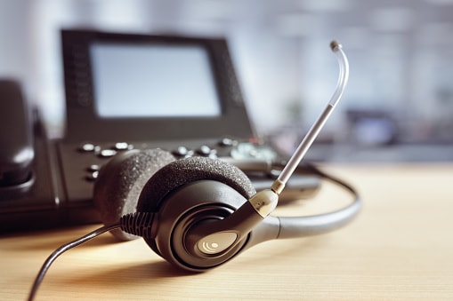 close-up of headset and phone on desk