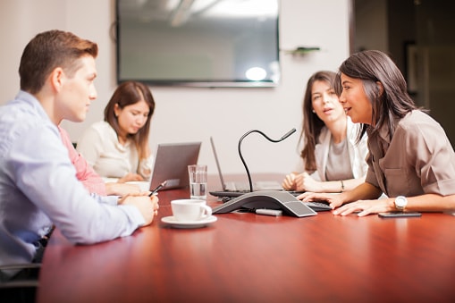 multiple people on a conference call in office