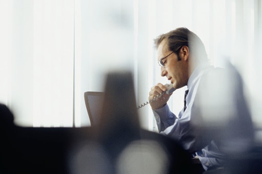 gentleman talking on the phone in his office