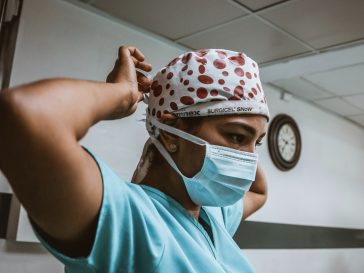 doctor putting on face mask and hair mask