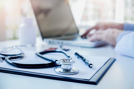 close-up of a stethoscope and laptop on computer