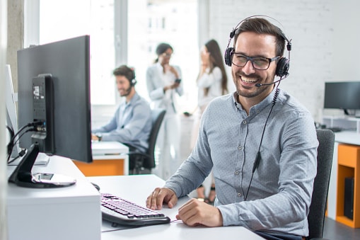 businessman sitting at desk with headset on
