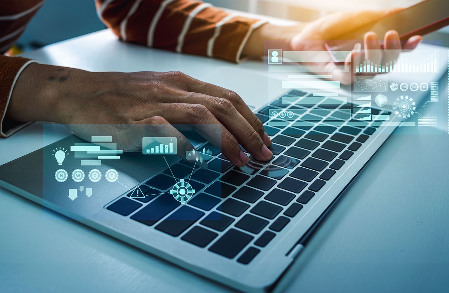 user working on a computer with cybersecurity symbols overlaid