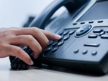 close up of person using business phone system