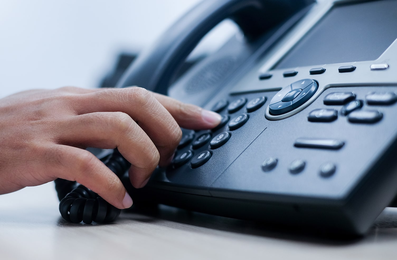 close up of person using business phone system