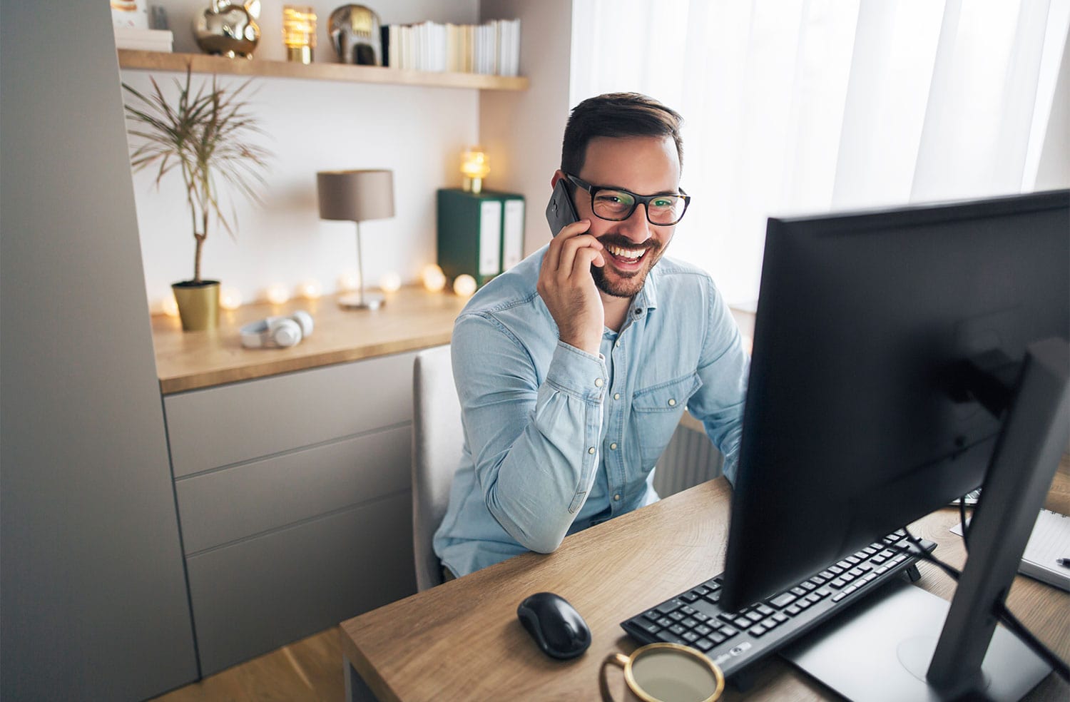 remote worker on company phone and computer